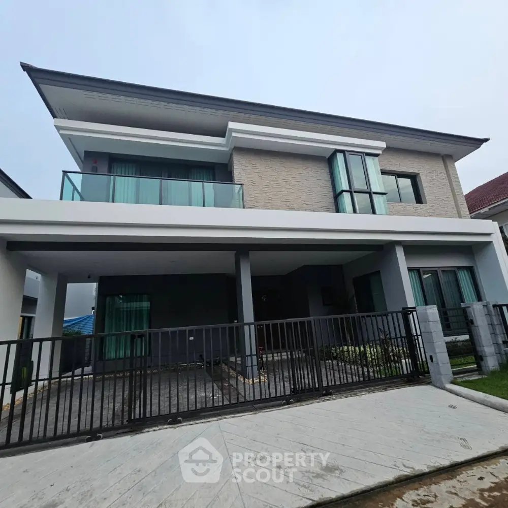 Modern two-story house with large balcony and sleek design