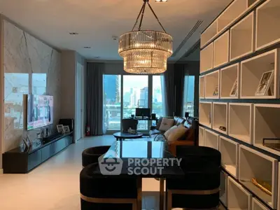 Luxurious living room with elegant chandelier and city view, featuring modern decor and spacious layout.
