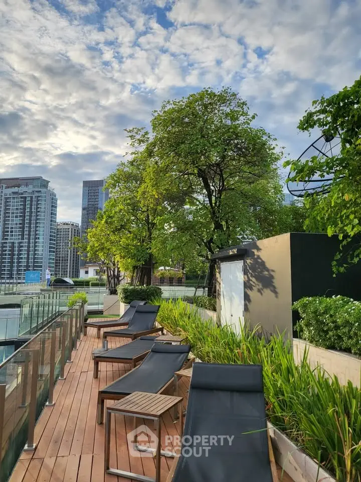 Luxurious rooftop terrace with city skyline view and modern lounge chairs.