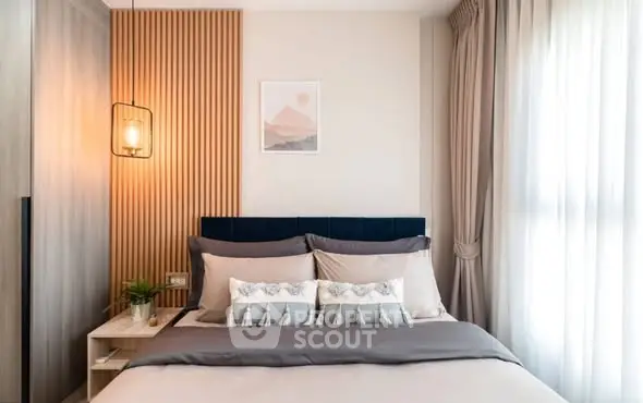 Modern bedroom with stylish decor and natural light