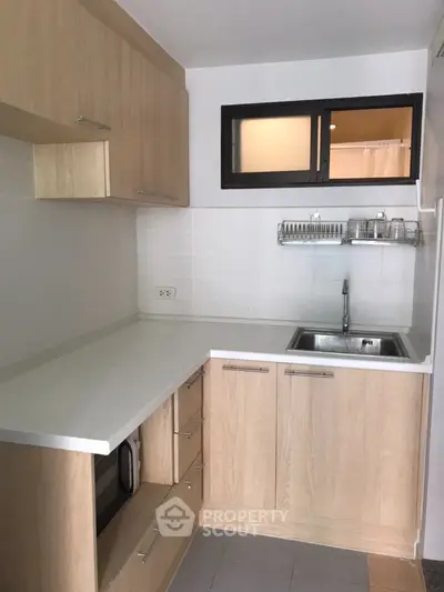 Modern compact kitchen with sleek cabinetry and stainless steel sink