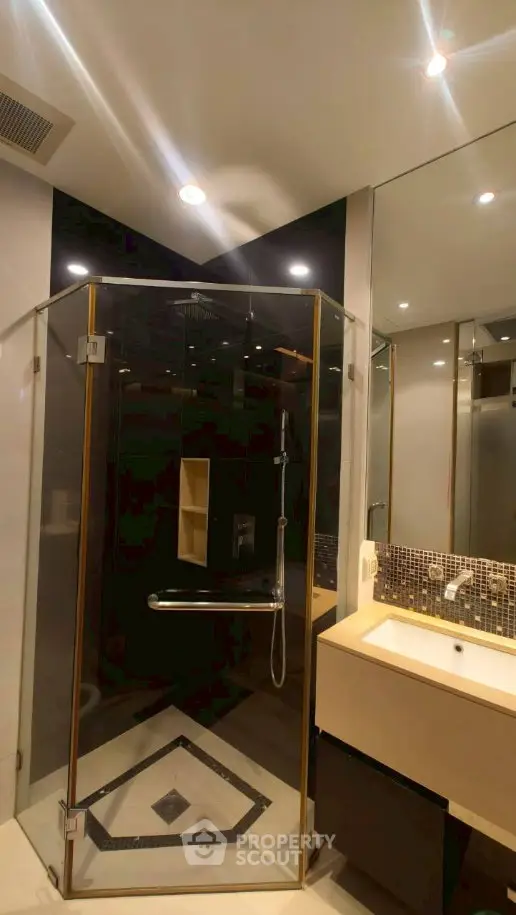 Modern bathroom with glass shower enclosure and stylish vanity