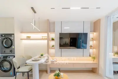 Modern living room with sleek design, built-in TV, and in-unit laundry for ultimate convenience.