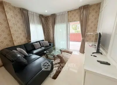 Elegant living room with modern decor, large sectional sofa, and natural light from sliding glass doors.