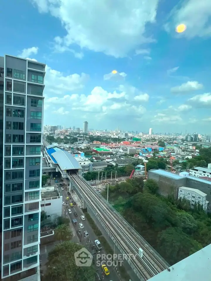 Stunning cityscape view from high-rise building with clear skies and urban skyline.