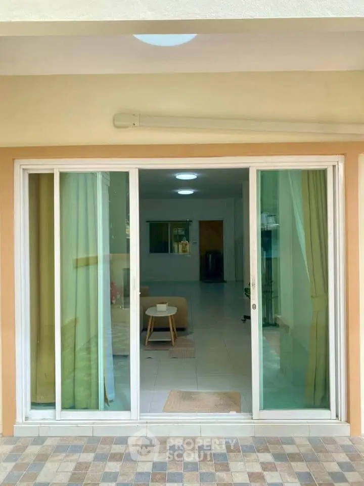 Spacious apartment with sliding glass doors opening to a cozy living area, perfect for modern living.