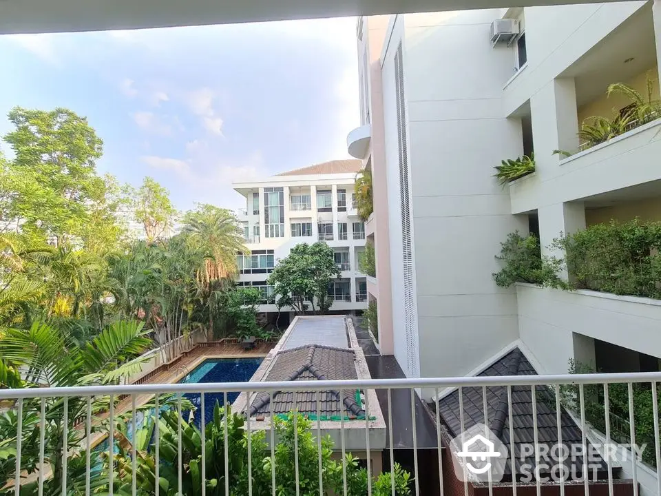 Stunning condo view with lush greenery and poolside tranquility