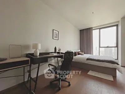 Modern bedroom with city view, featuring a sleek desk and comfortable bed in a high-rise apartment.