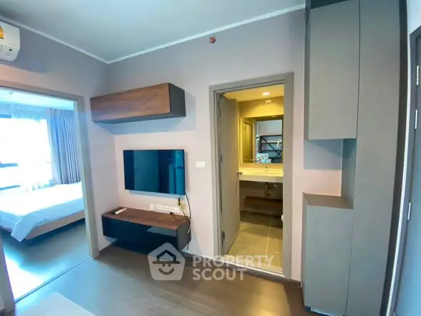 Modern apartment interior with living room and bathroom view, featuring sleek design and contemporary furnishings.