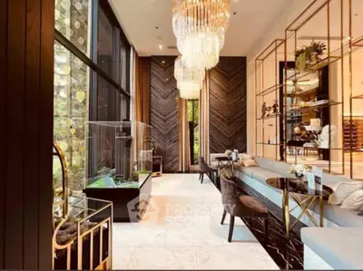 Luxurious modern living room with high ceilings, elegant chandeliers, and floor-to-ceiling windows.