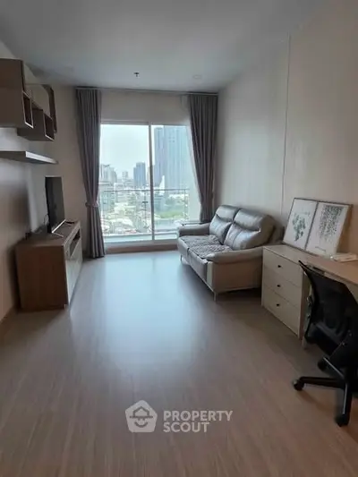 Spacious living room with city view, modern furniture, and natural light.