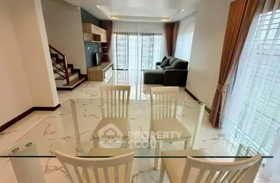 Spacious modern living room with elegant marble flooring and large windows for natural light.