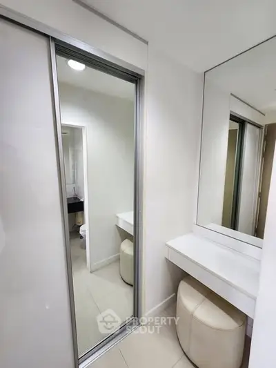 Modern bathroom with sleek design and mirrored closet doors