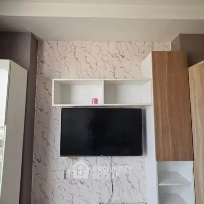 Modern living room with mounted TV and stylish storage units