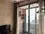 Spacious living room with large windows and balcony access, offering a bright and airy atmosphere.