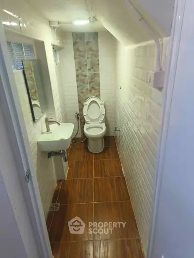 Compact bathroom with modern fixtures and stylish tile design, perfect for maximizing small spaces.