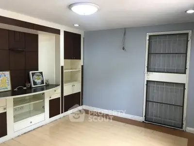 Spacious living room with built-in shelving and modern lighting