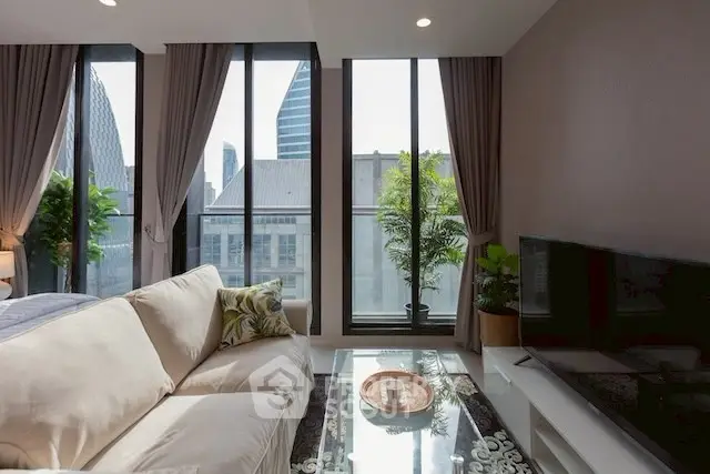 Modern living room with large windows and city view, featuring cozy sofa and stylish decor.