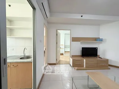 Modern living room with sleek furniture and open kitchen view
