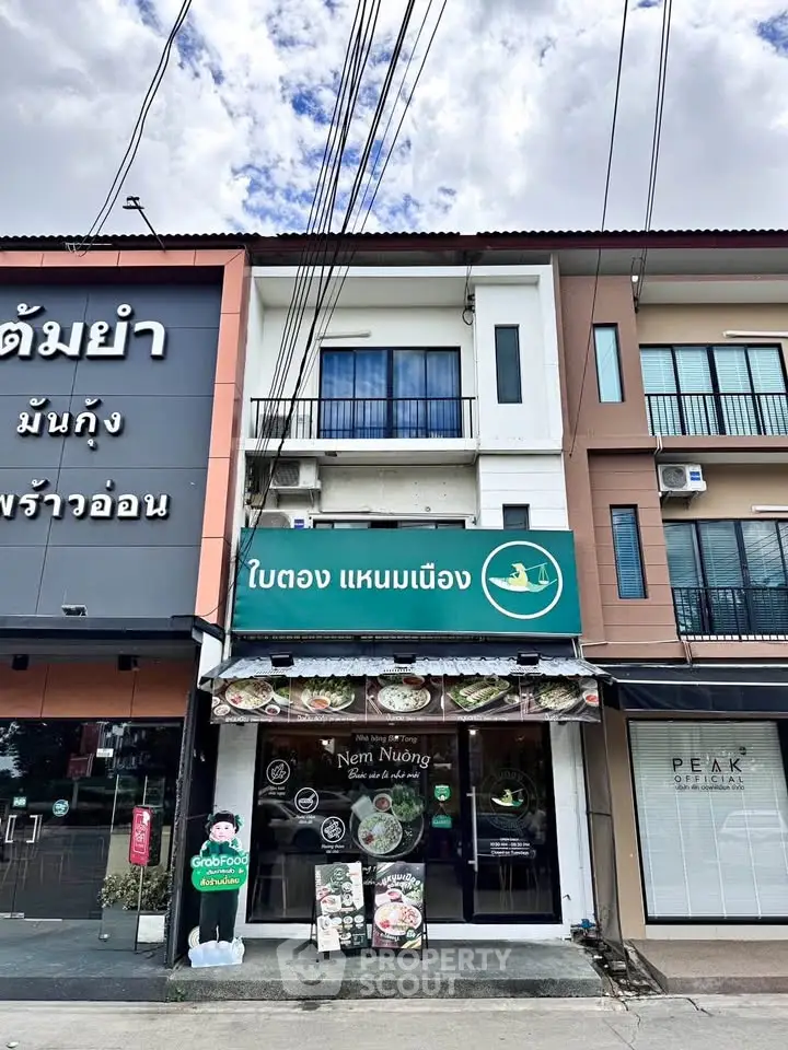 Charming commercial building with restaurant space on ground floor and residential units above.