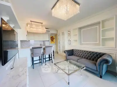 Elegant living room with luxurious chandelier and modern open kitchen layout