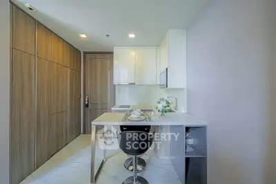 Modern kitchen with sleek design, featuring a marble countertop and integrated appliances.