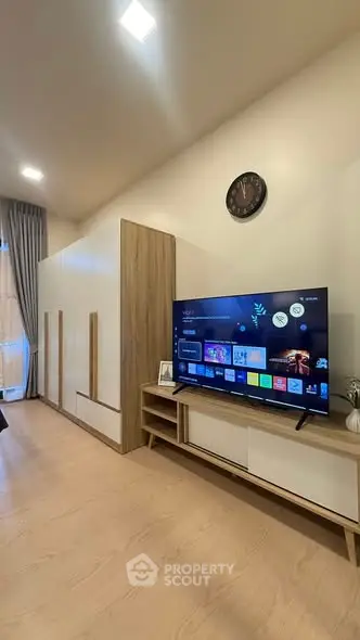 Modern living room with sleek TV setup and stylish wooden furniture