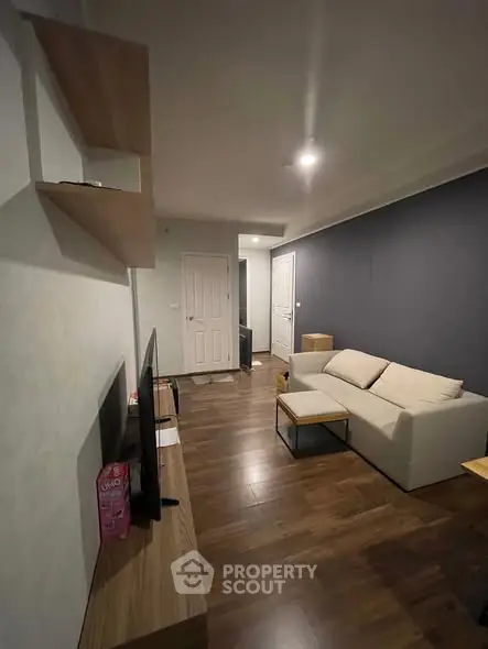 Modern living room with sleek furniture and wooden flooring