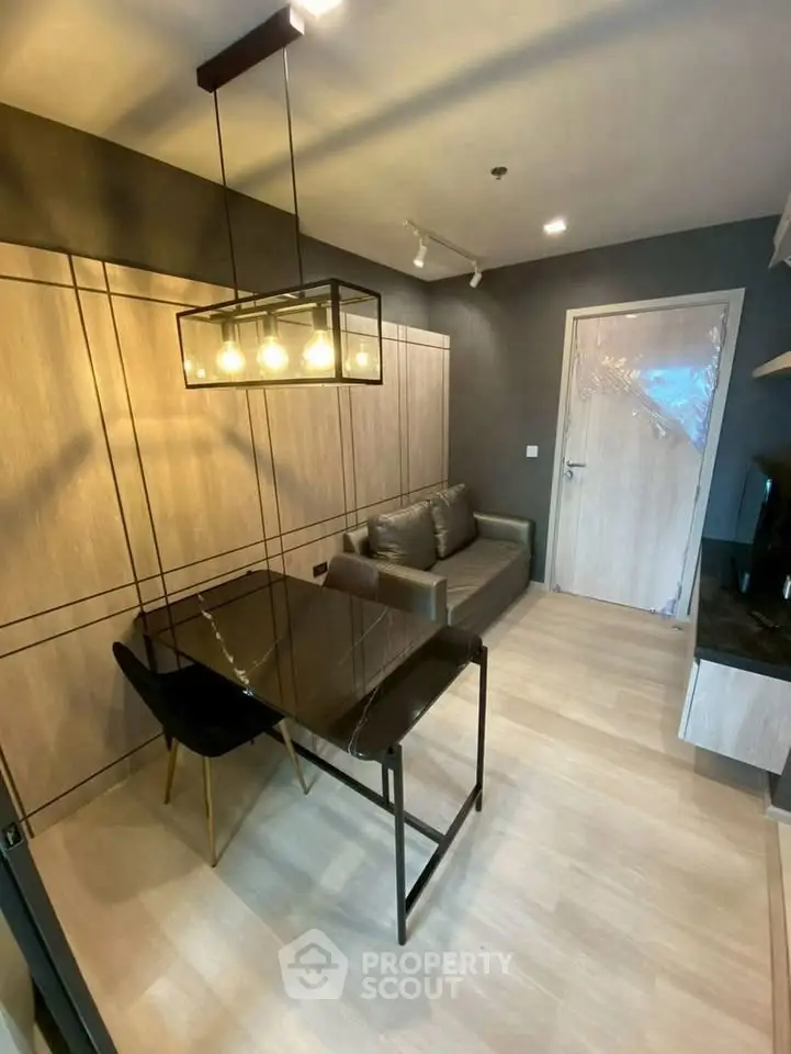 Modern living room with sleek furniture and stylish lighting in a contemporary apartment.