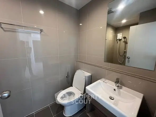 Modern bathroom with sleek fixtures and neutral tiles