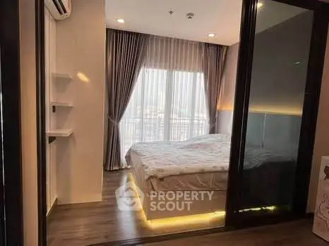 Modern bedroom with floor-to-ceiling windows and stylish lighting