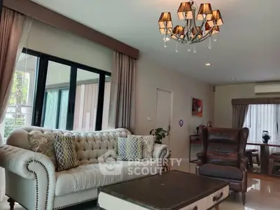 Elegant living room with plush sofa and stylish chandelier in modern home