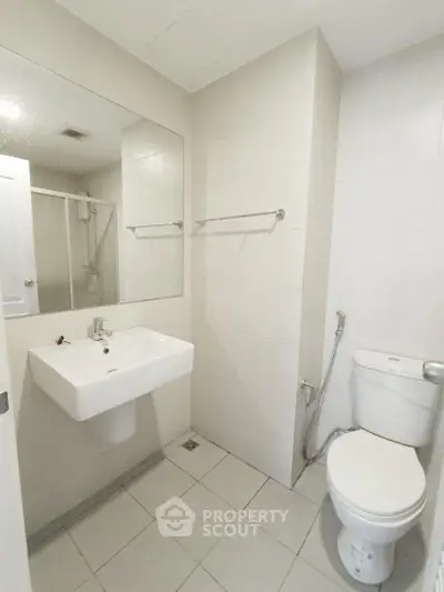 Modern bathroom with sleek white fixtures and minimalist design