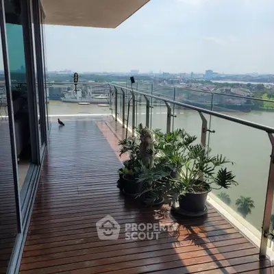 Luxurious balcony with stunning river view and elegant wooden flooring, perfect for relaxation and entertainment.