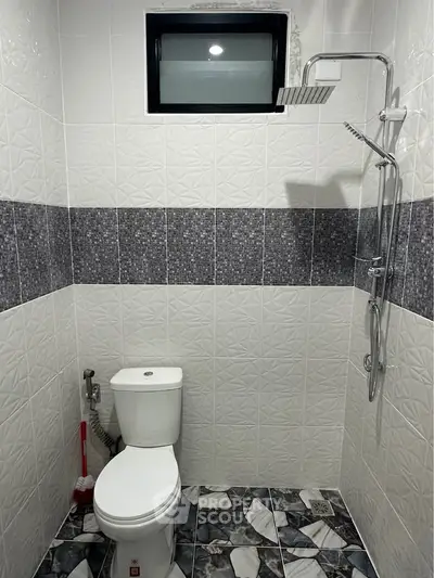 Modern bathroom with stylish tile design and rainfall showerhead