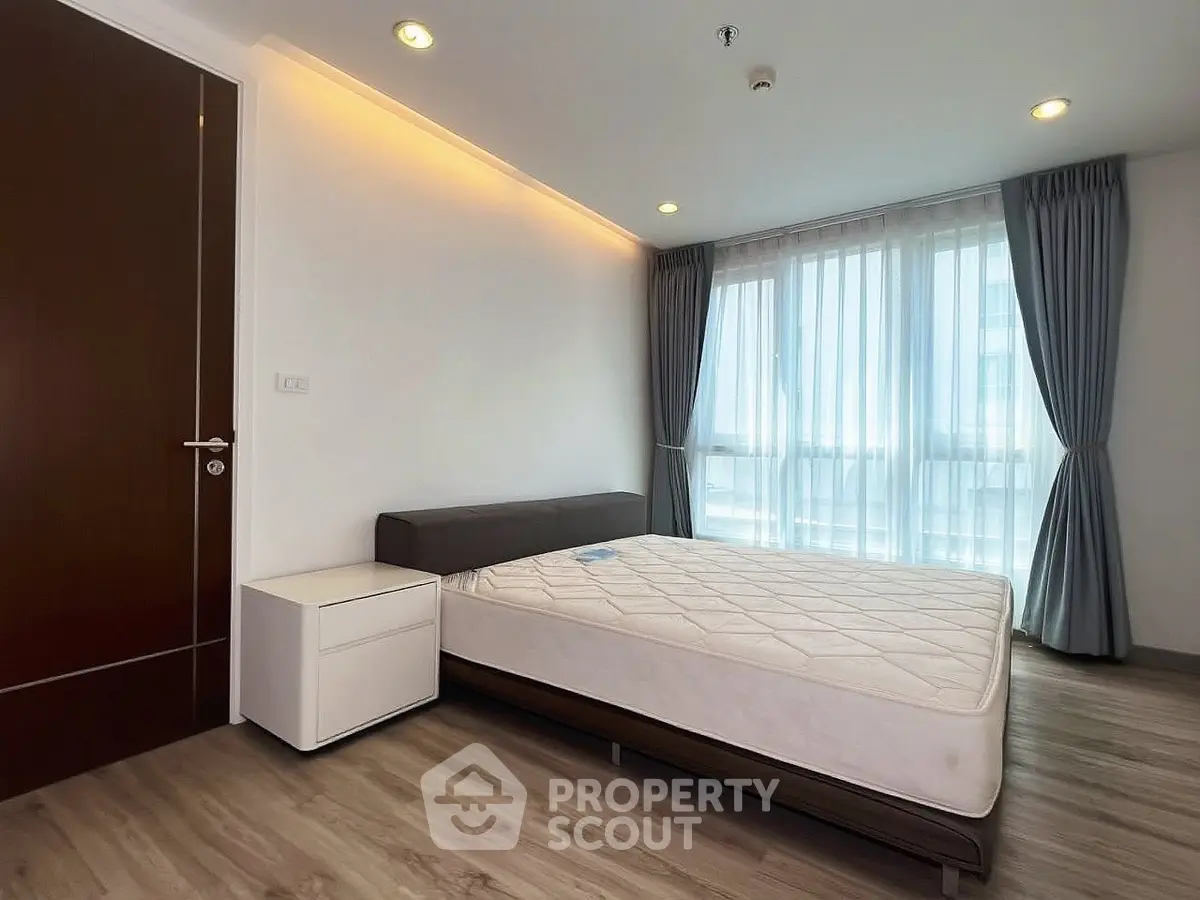 Modern bedroom with large window and minimalist design