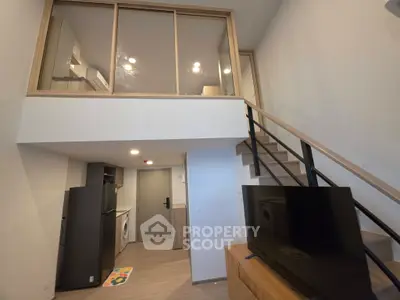 Modern loft apartment with mezzanine, sleek kitchen, and stylish living area.