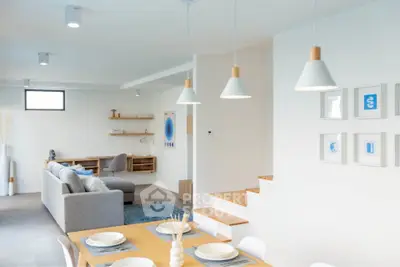 Modern open-plan living and dining area with stylish decor and ample natural light.