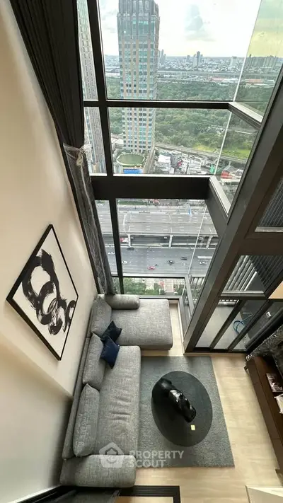 Stunning high-rise living room with floor-to-ceiling windows offering breathtaking city views.