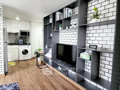 Modern living room with stylish shelving and integrated washing machine in open layout.