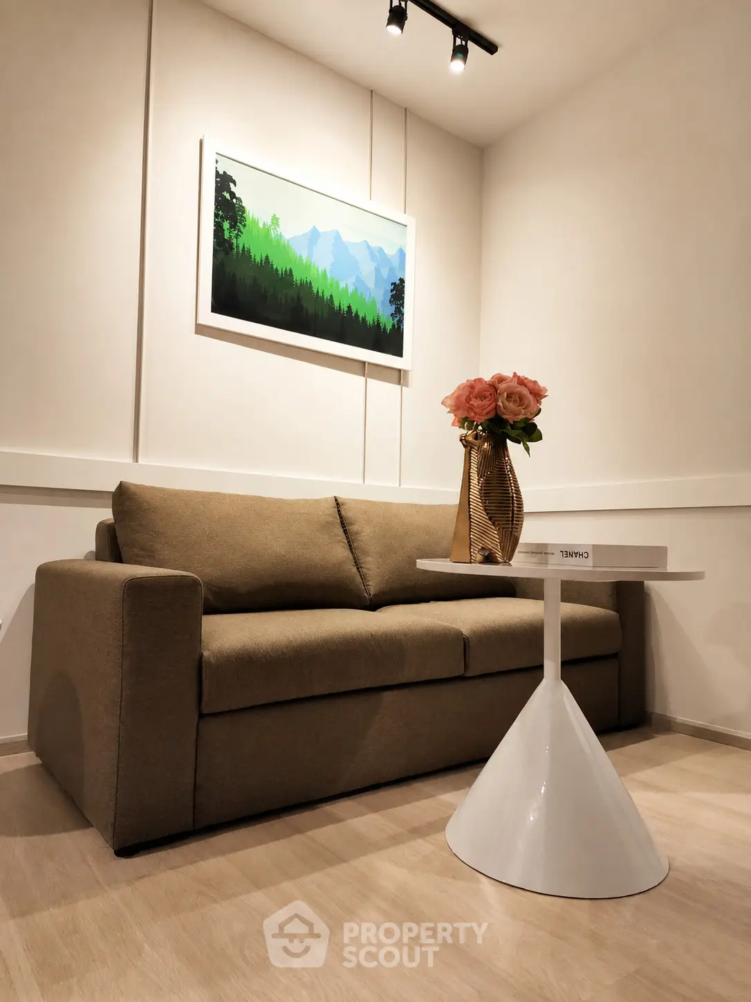 Cozy living room with modern sofa, stylish table, and elegant decor in a well-lit space.