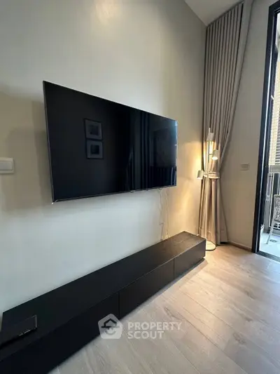 Modern living room with sleek TV setup and elegant lighting