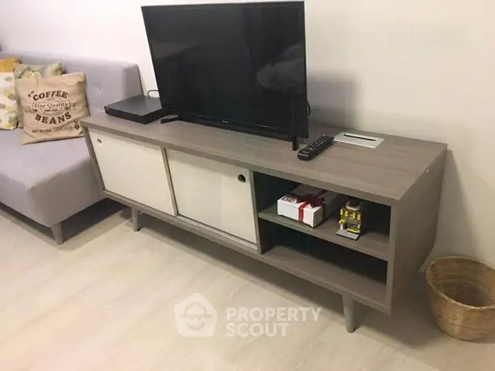Modern living room with sleek TV stand and cozy sofa, perfect for relaxation and entertainment.