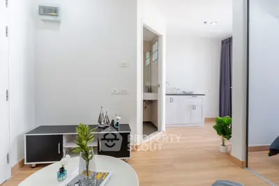 Modern apartment interior with sleek furniture and wooden flooring, showcasing a bright and inviting living space.