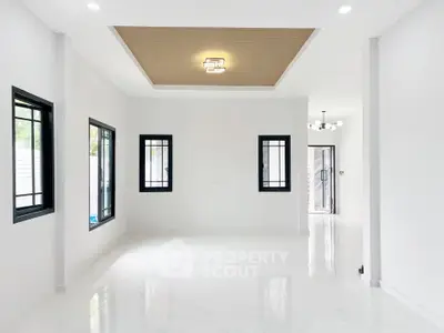 Spacious modern living room with elegant ceiling design and large windows