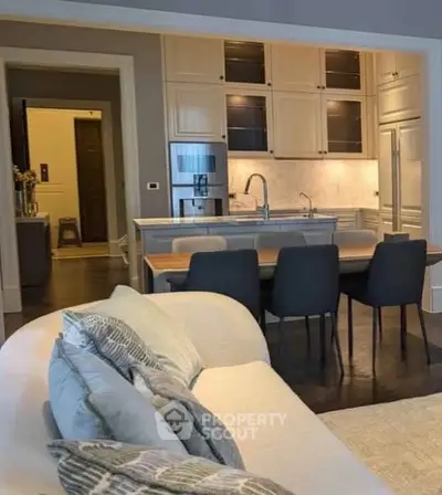 Elegant open-layout kitchen with modern appliances and cozy living area, perfect for contemporary living.