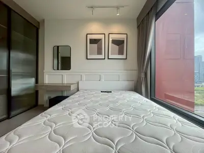 Modern bedroom with large window and stylish decor in urban apartment