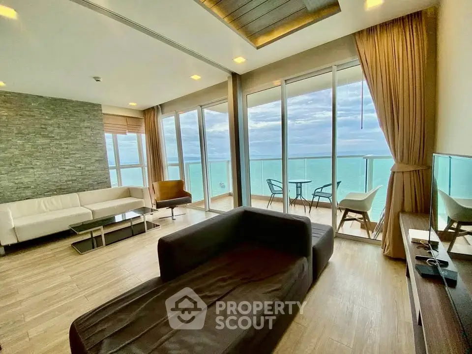 Luxurious living room with stunning ocean view and spacious balcony in modern apartment.