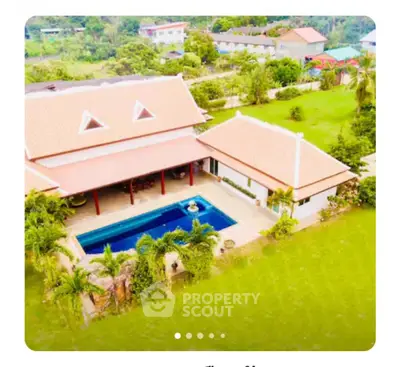 Stunning aerial view of luxury villa with private pool and lush garden