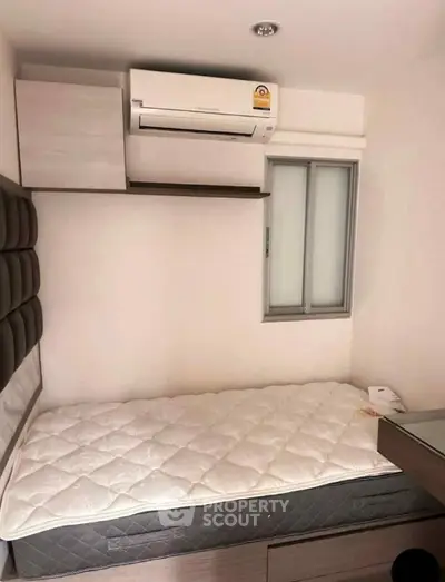Cozy bedroom with air conditioning and modern furnishings, perfect for comfortable living.